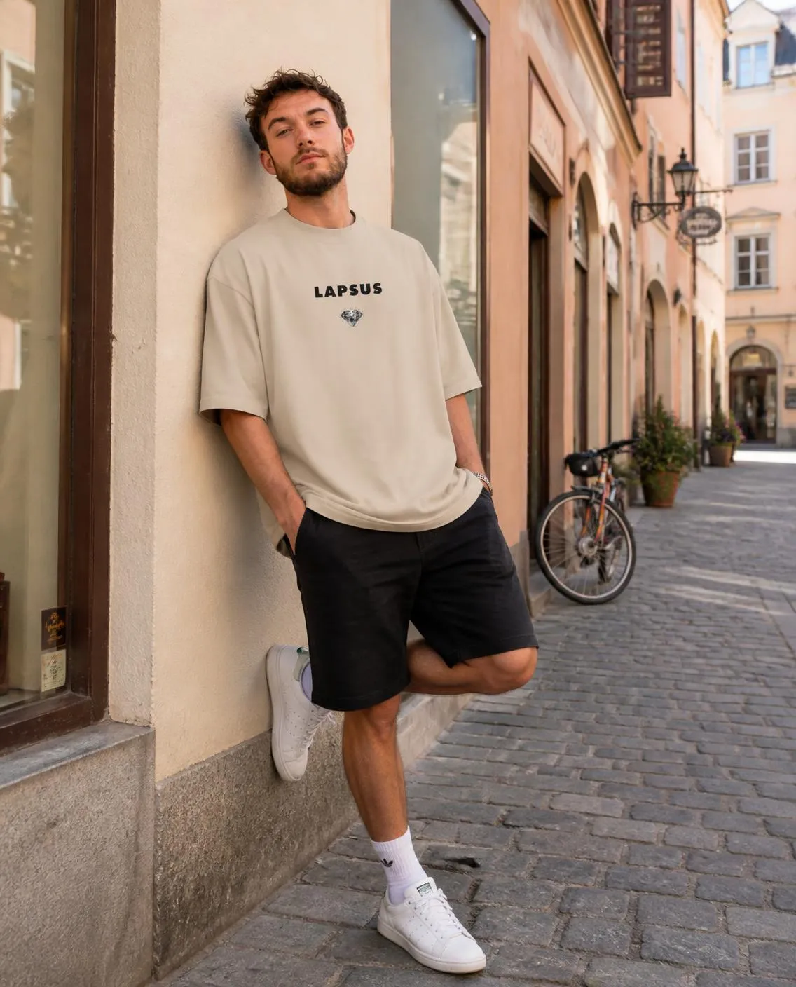 Beige T-shirt leaning on a sunlit wall