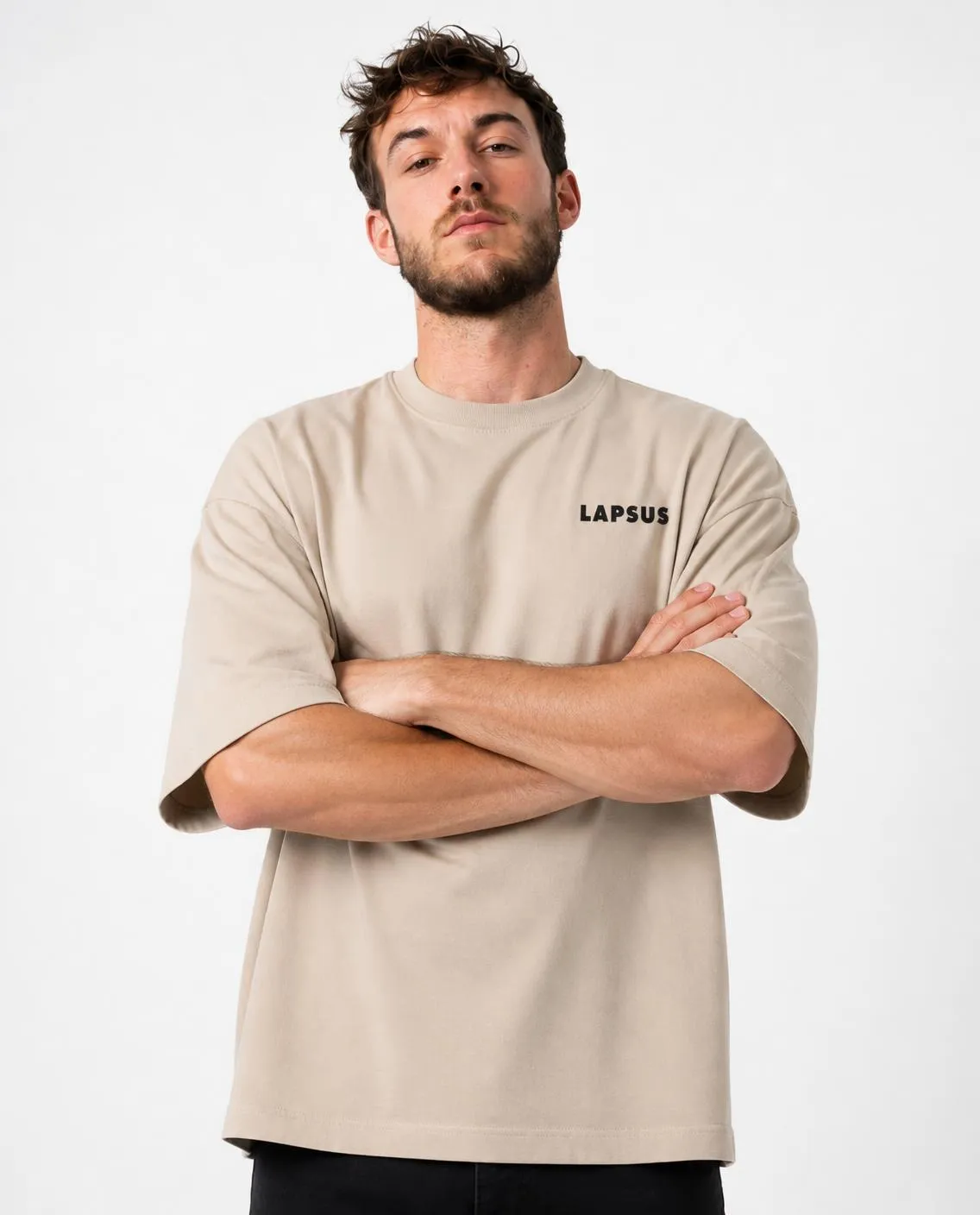 Cream T-shirt in the studio, arms crossed