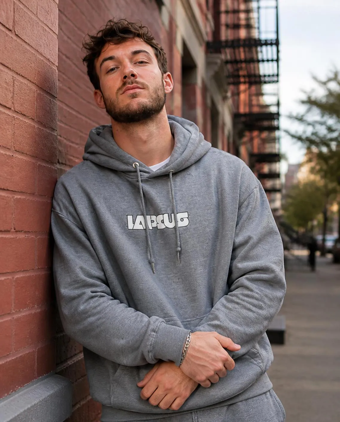Grey hoodie against a brick wall