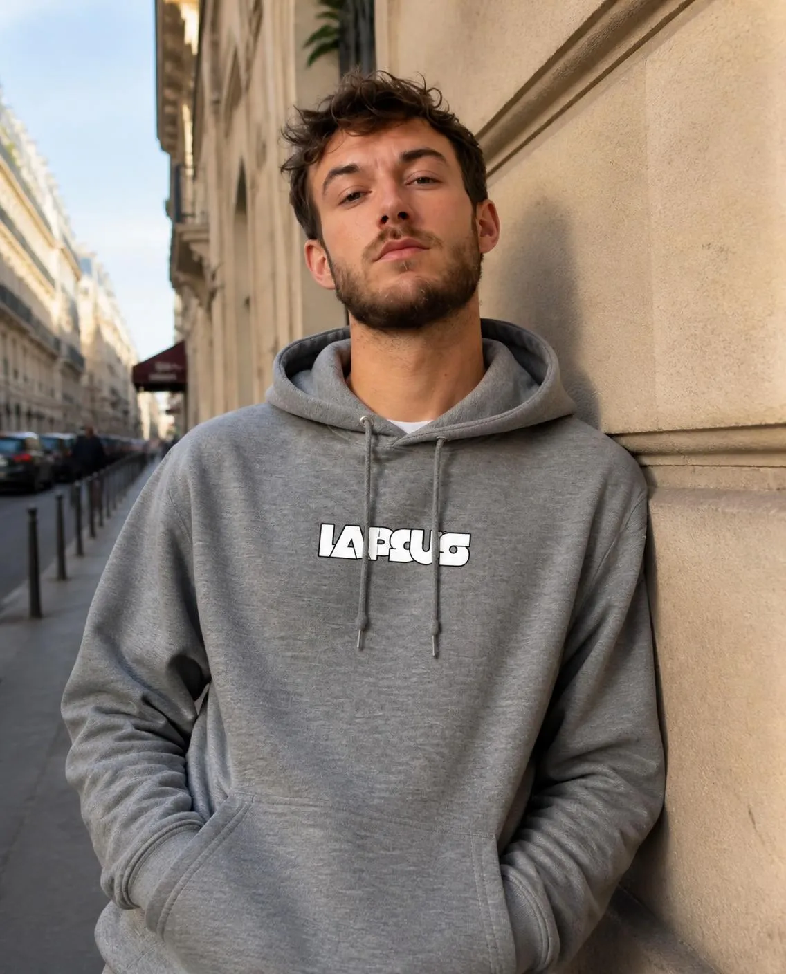 Grey hoodie in a sunlit street