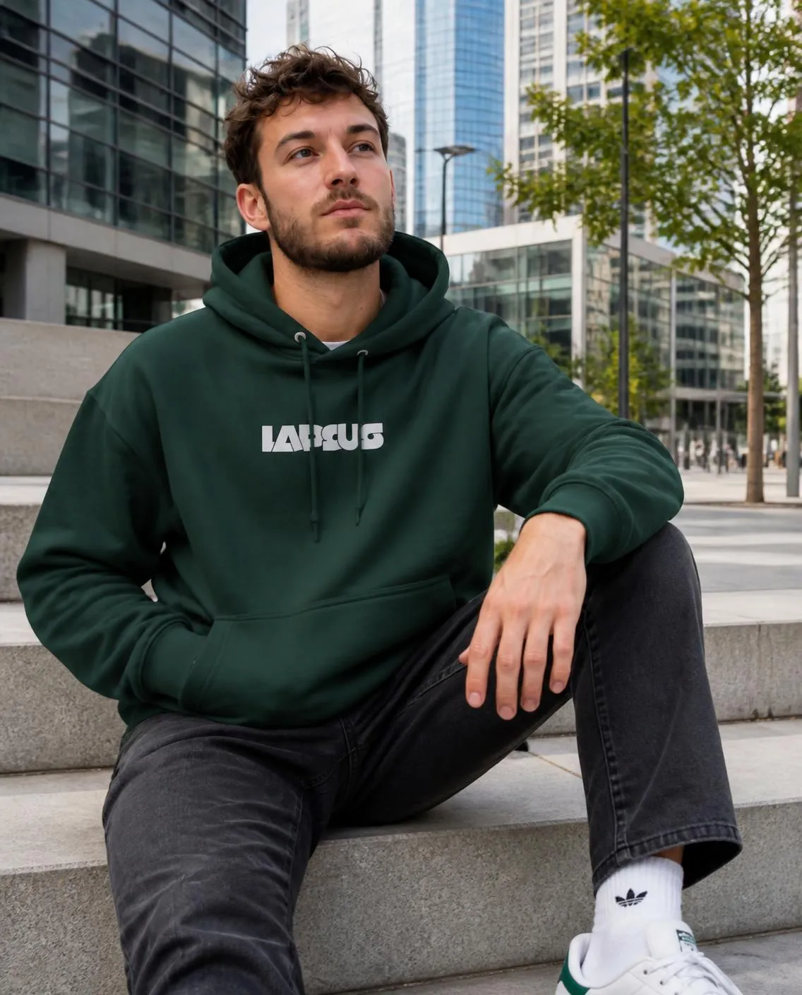 Forest green hoodie seated on steps